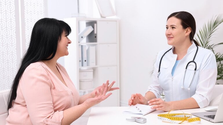 Frau in den Wechseljahren wird von Ärztin wegen Gewichtszunahme beraten