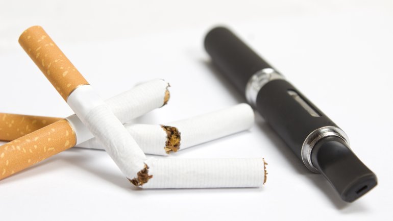 Das Bild zeigt durchbrochenen Zigaretten und eine E-Zigarette.