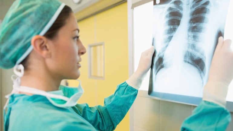 Eine Chirurgin betrachtet ein Röntgenbild.